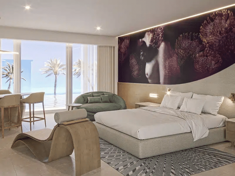 a bedroom with a large bed and a chair