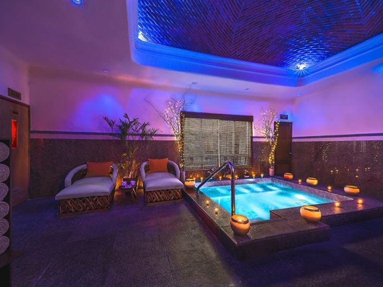 a indoor pool with candles and chairs