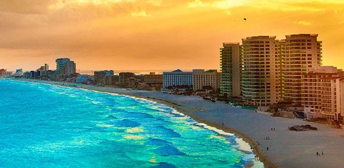 Beachfront hotels beside Cancun’s Caribbean coast in evening light