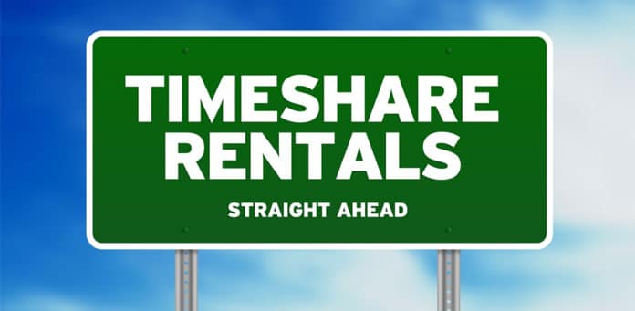 Green sign reading “Timeshare rentals straight ahead”