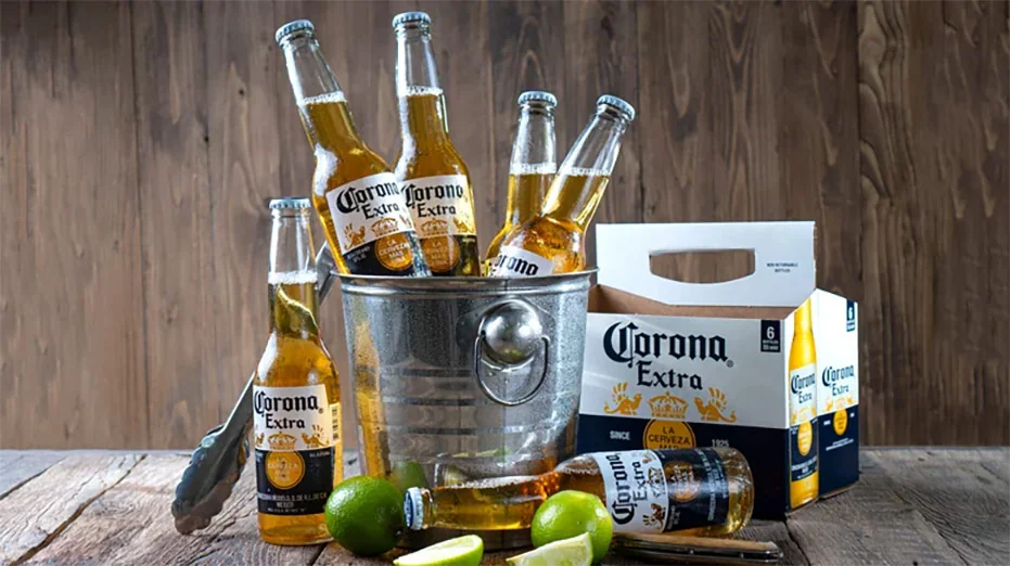 Corona Extra beer bottles with fresh limes in an ice bucket