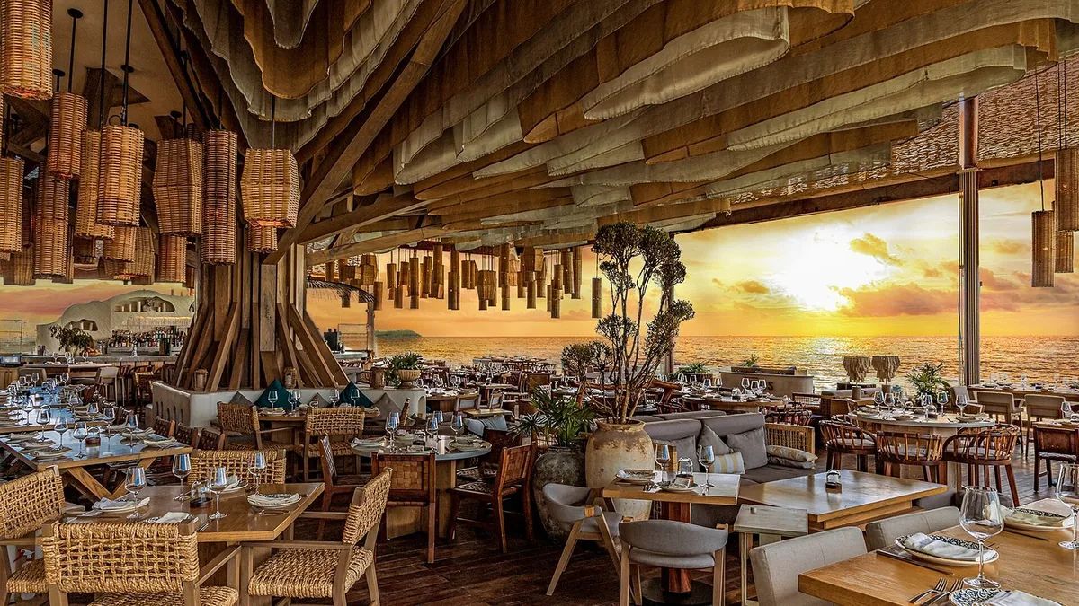 Ilios Cancun dining room overlooking the lagoon at sunset