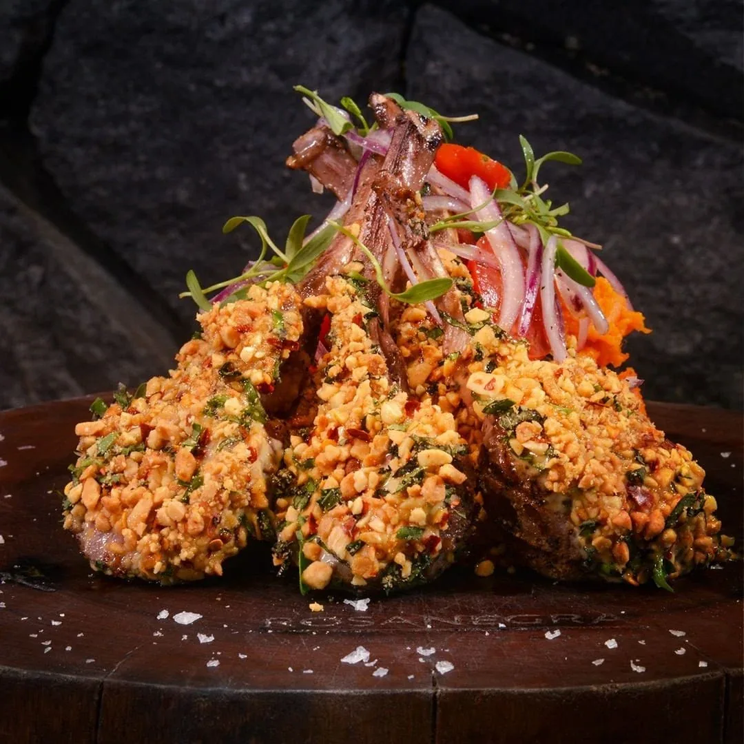 Meat dish with vegetables and chopped nuts at Rosa Negra Cancun