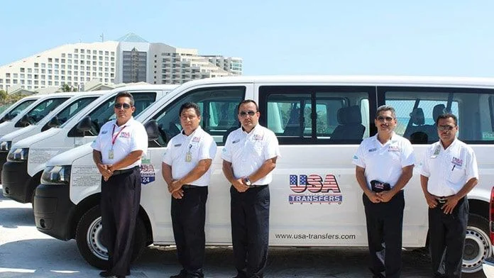 USA Transfers drivers beside a USA Transfers vehicle