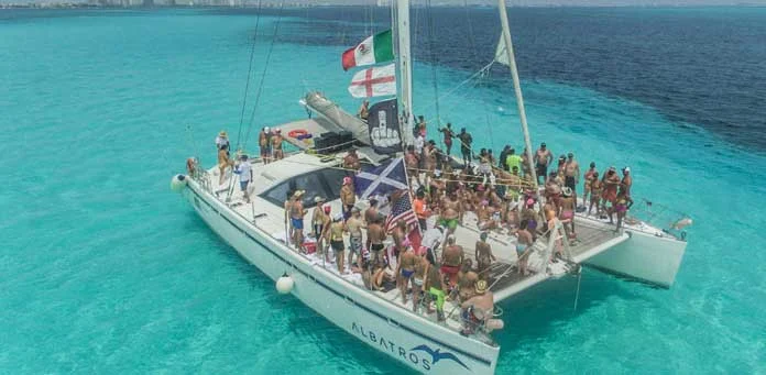 Guests aboard the Cancun Boobs Cruise catamaran