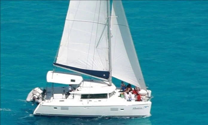 White catamaran sailing on turquoise Caribbean water