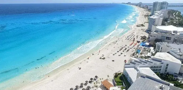Aerial view along Cancun’s white-sand beach and turquoise water