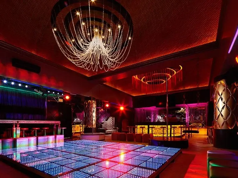 Red-lit Obsession nightclub and dance floor at Desire Pearl