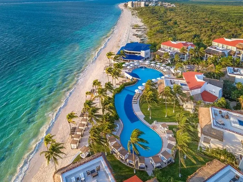 Aerial view of Desire Pearl Resort's pool beside the Puerto Morelos beach