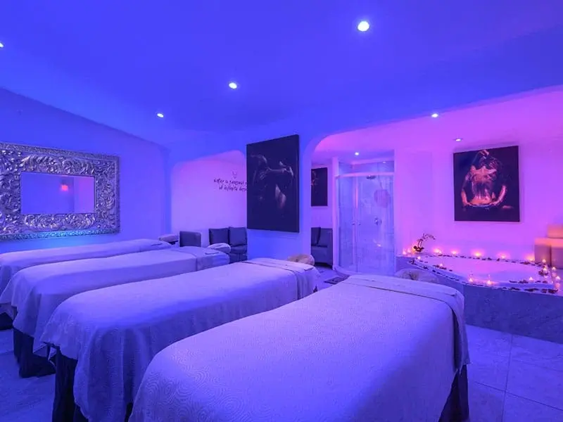 Purple-lit couple treatment room at Desire Allure Spa