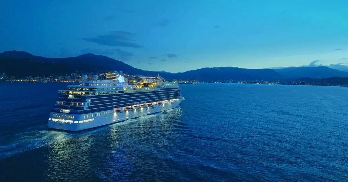 A cruise ship sailing at dusk in the operator’s Rome–Trieste imagery