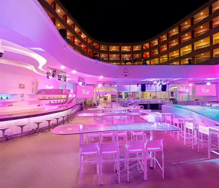 Bash main bar and open-air seating at night at Temptation Cancun Resort