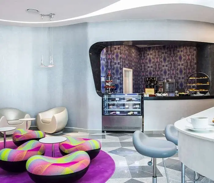 Seating and coffee counter inside Caffeine café at Temptation Cancun Resort