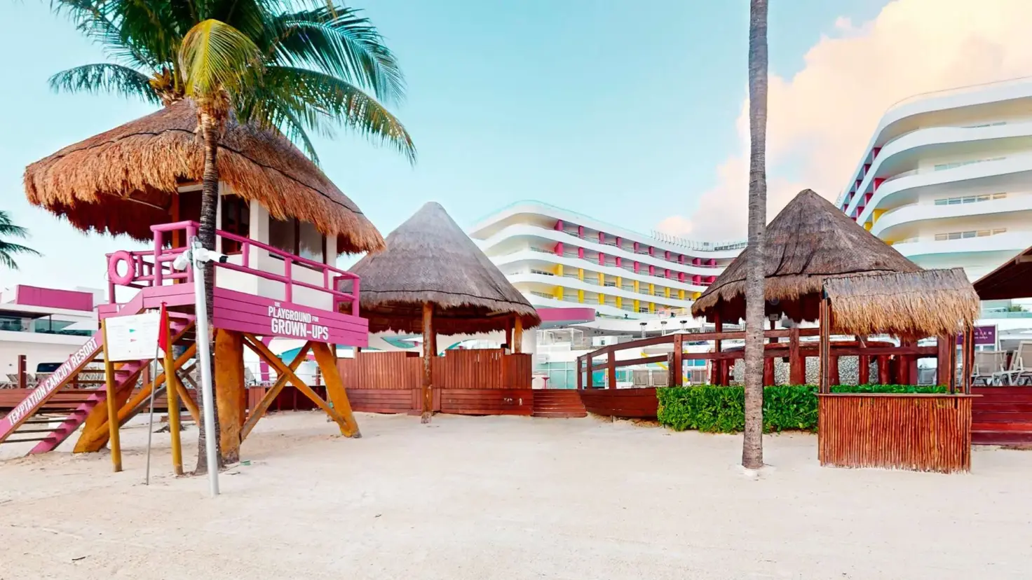 Palapa shelters and sand on the beach at Temptation Cancun Resort