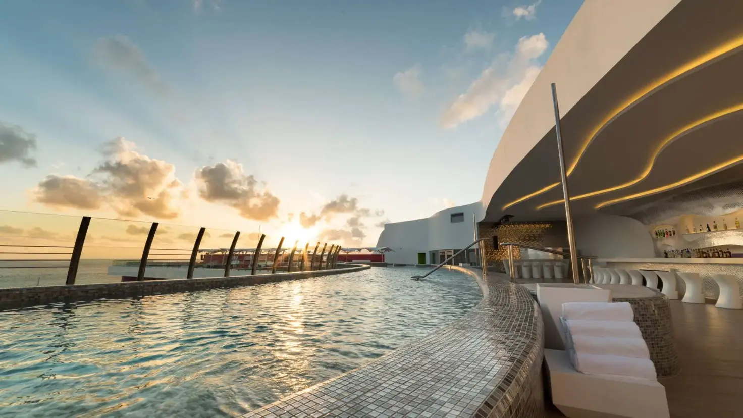 Temptation Cancun Resort rooftop pool and loungers at sunset