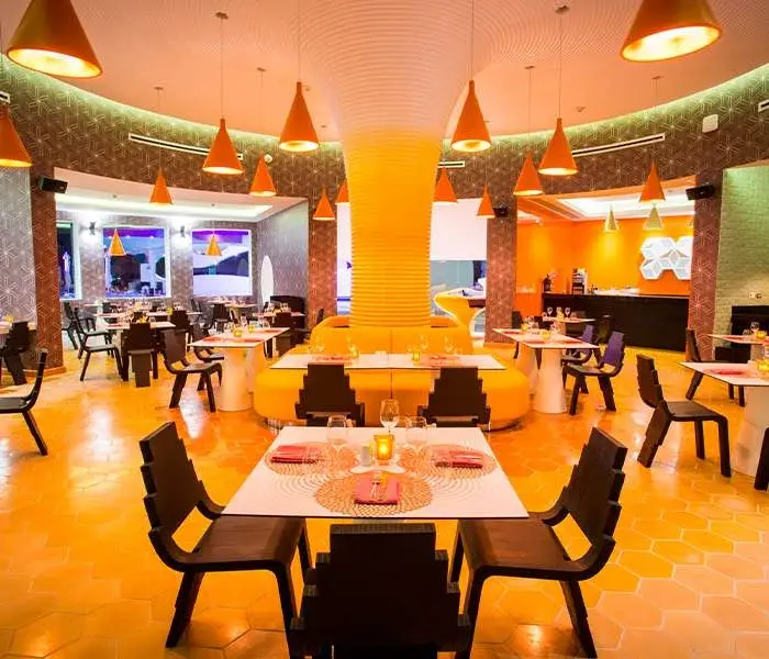 Warmly lit dining room at Flame grill restaurant in Temptation Cancun Resort