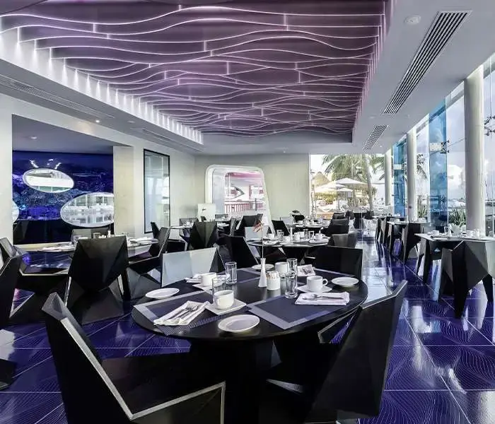 Tables set inside Sea Flirt seafood restaurant at Temptation Cancun Resort