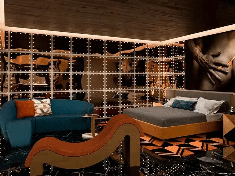 Bed and blue sofa in a Diamond Ocean-View suite at The Eden