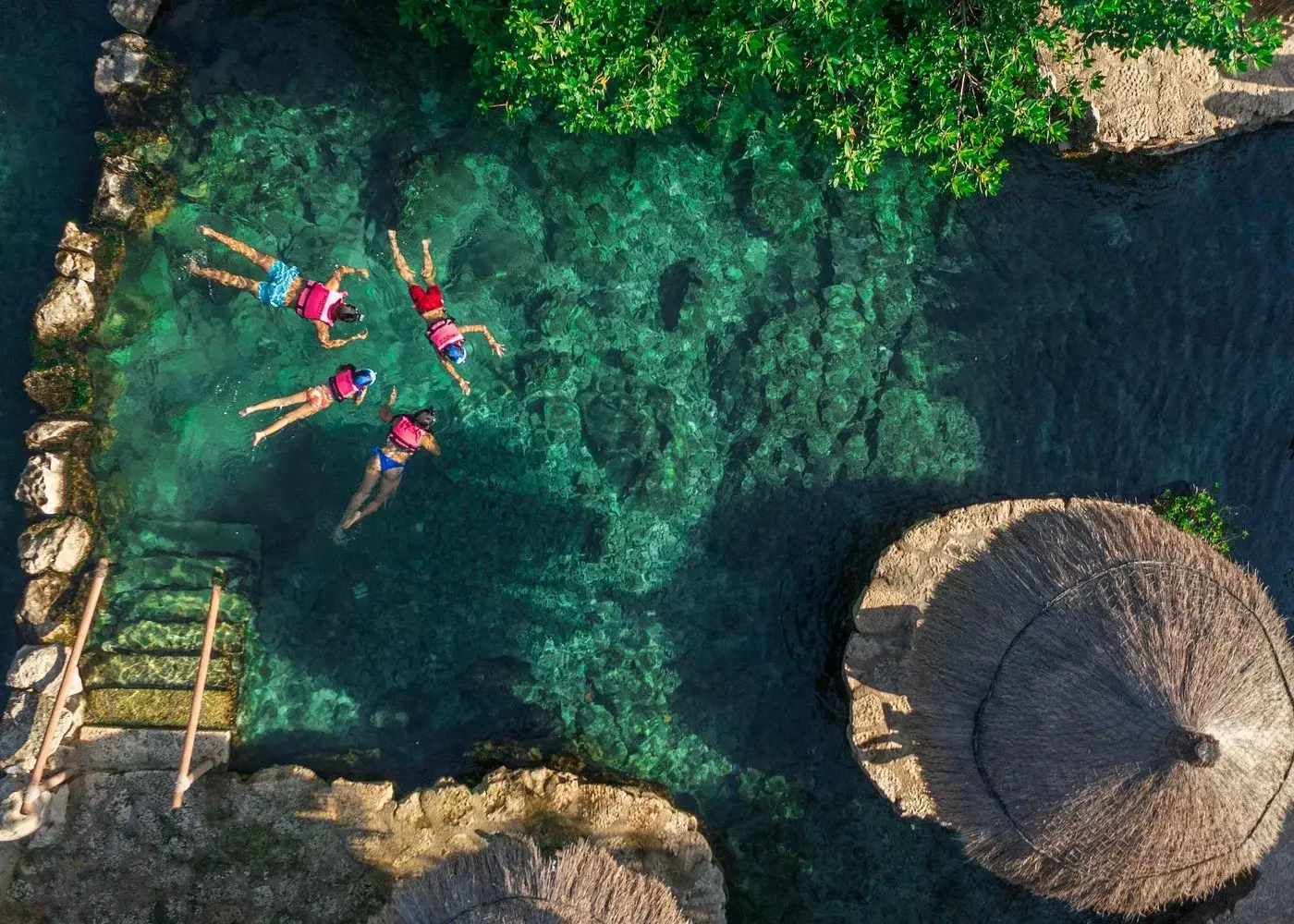Aerial view of visitors floating in clear water at Xcaret