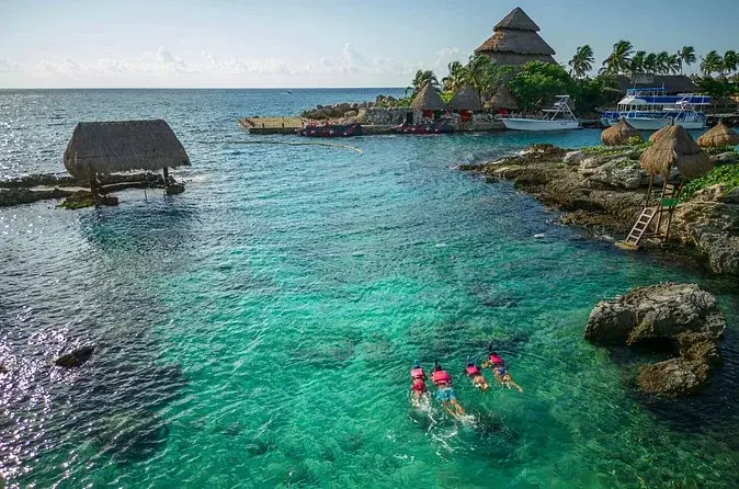 Visitors swimming in Xcaret’s turquoise coastal inlet