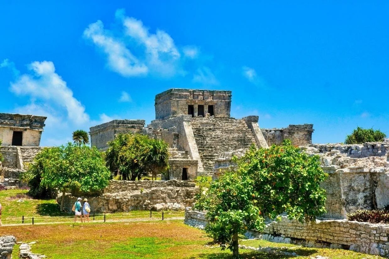 El Castillo and surrounding Tulum ruins beneath a blue sky
