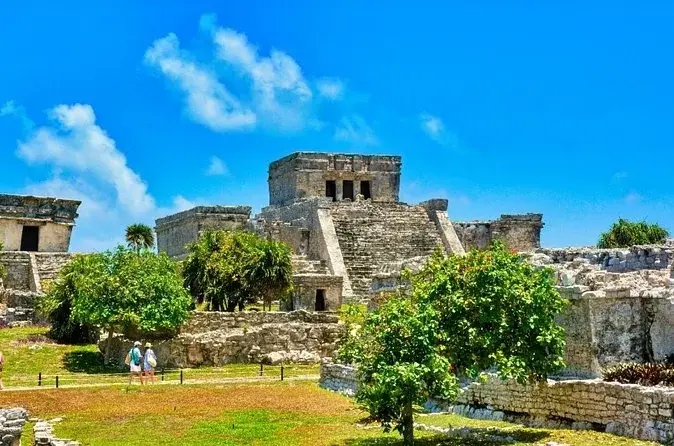 El Castillo and the coastal ruins at Tulum beneath a blue sky