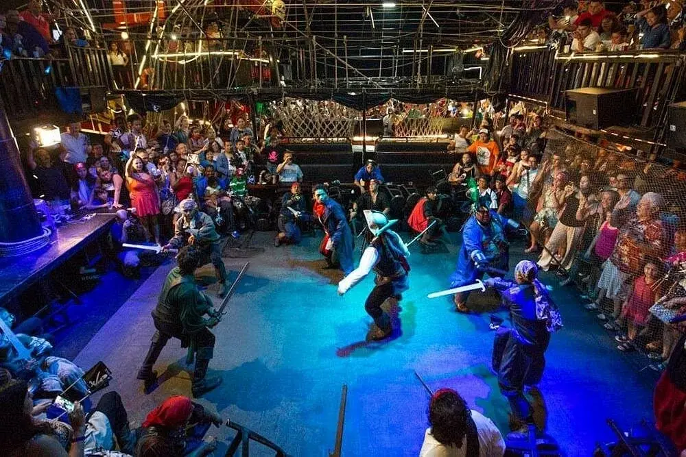 Pirate performers staging a sword fight aboard the Captain Hook galleon