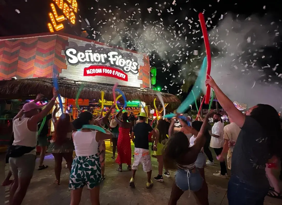 Crowd celebrating outside Señor Frog's at the start of a Cancun bar crawl