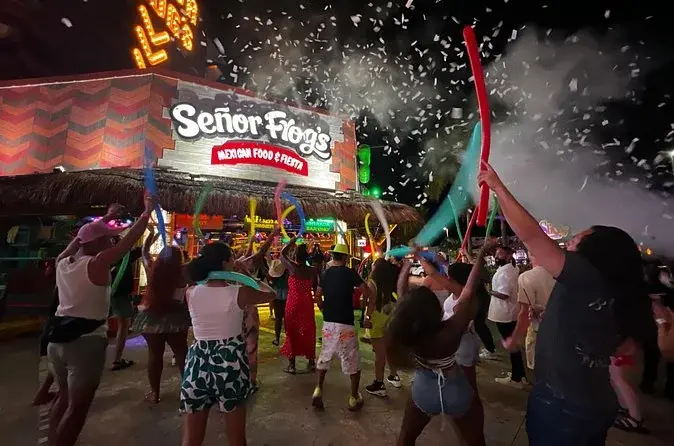 Crowd celebrating outside Señor Frog's at the start of a Cancun bar crawl